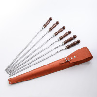 A set of skewers 670*12*3 mm in an orange leather case